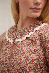 Floral Liberty tana lawn blouse. Top. Frill detail on elasticised sleeve. Over the head blouse, Ruffled collar. Ric-rac trim. Curved hem. Cut long. 100% cotton