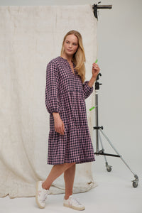 Pink/Navy gingham Irish linen midi dress. Easy fit. Tiered dress. Notch neck topped with tiny ruffle Pockets. Hook and eye at neck. Unlined. Midi length. Long sleeves. Easy fit. 100% Irish linen